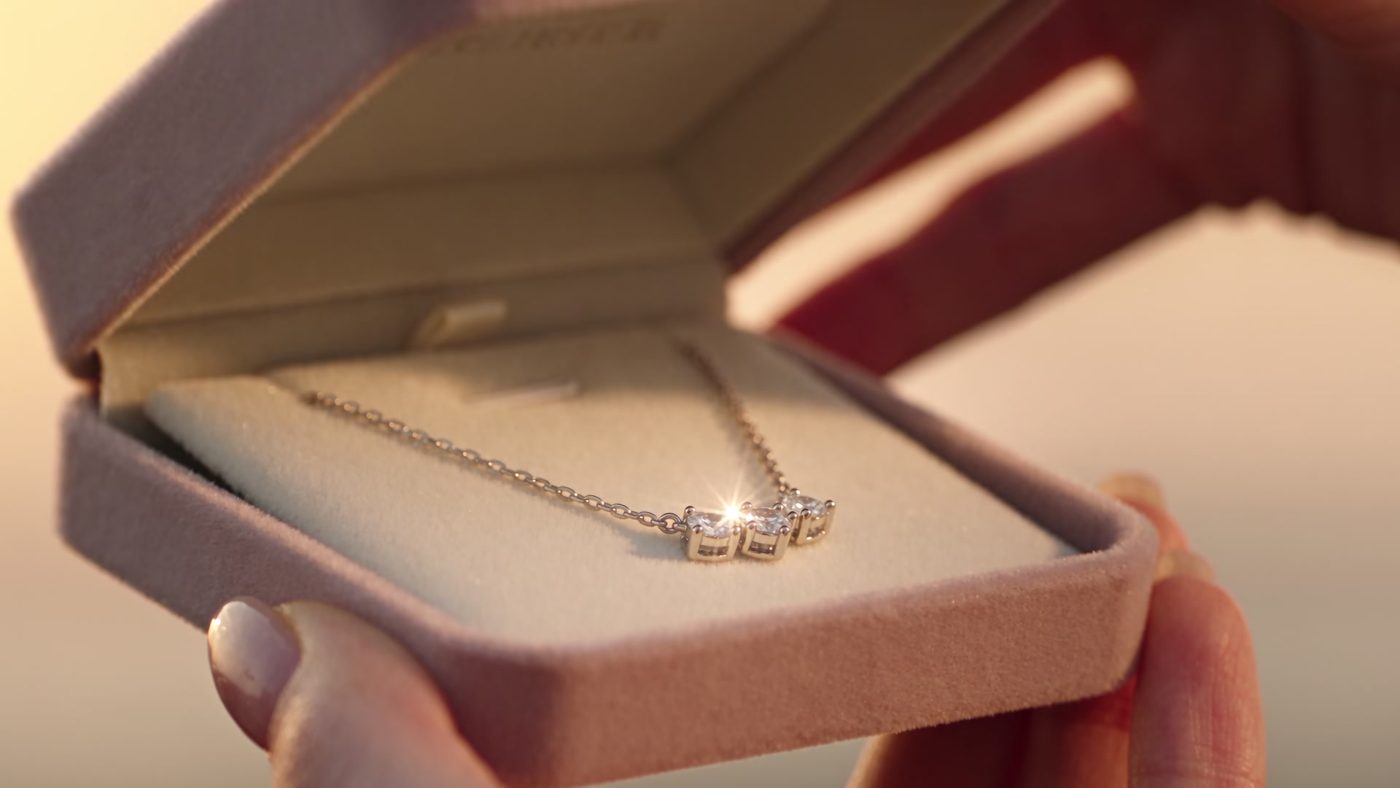 Starry Co pendant necklace in an open gift box at sunset